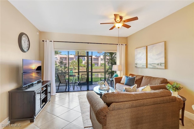 living area with ceiling fan, light tile patterned floors, and baseboards