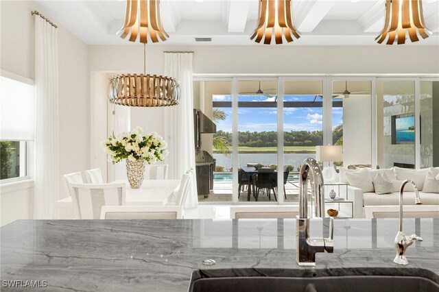 18492 Miromar Lakes Blvd W, Miromar Lakes, FL 33913 - interior space featuring a sink, a water view, and a chandelier