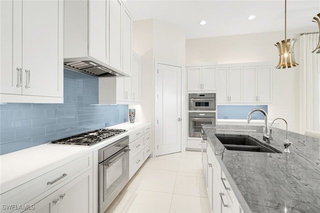 18492 Miromar Lakes Blvd W, Miromar Lakes, FL 33913 - kitchen featuring a sink, stainless steel gas stovetop, tasteful backsplash, and white cabinets