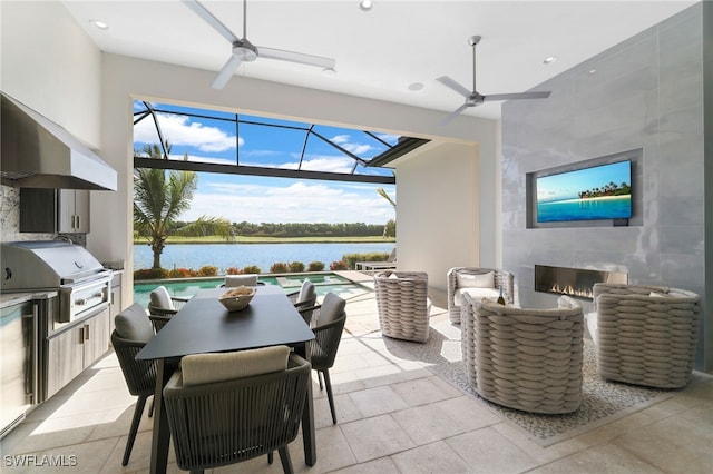 18492 Miromar Lakes Blvd W, Miromar Lakes, FL 33913 - view of patio / terrace with a tiled fireplace, a ceiling fan, a grill, exterior kitchen, and a water view