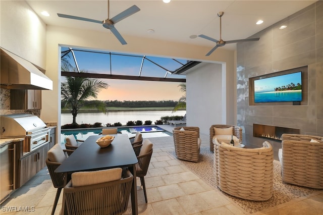 18492 Miromar Lakes Blvd W, Miromar Lakes, FL 33913 - view of patio / terrace with a ceiling fan, a grill, exterior kitchen, and a tiled fireplace