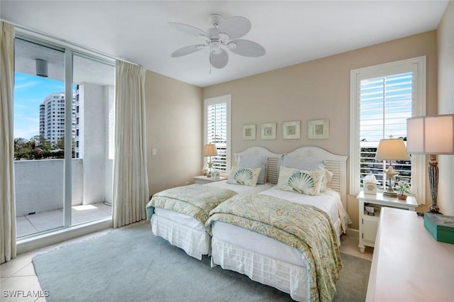315 Dunes Blvd Unit 307, Naples, FL 34110 - bedroom featuring multiple windows, access to exterior, and ceiling fan