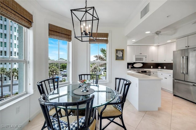 315 Dunes Blvd Unit 307, Naples, FL 34110 - dining area with healthy amount of natural light, light tile patterned floors, crown molding, a chandelier, and recessed lighting