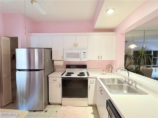 1096 Woodshire Ln Unit C205, Naples, FL 34105 - kitchen featuring white appliances, a sink, white cabinets, and light countertops