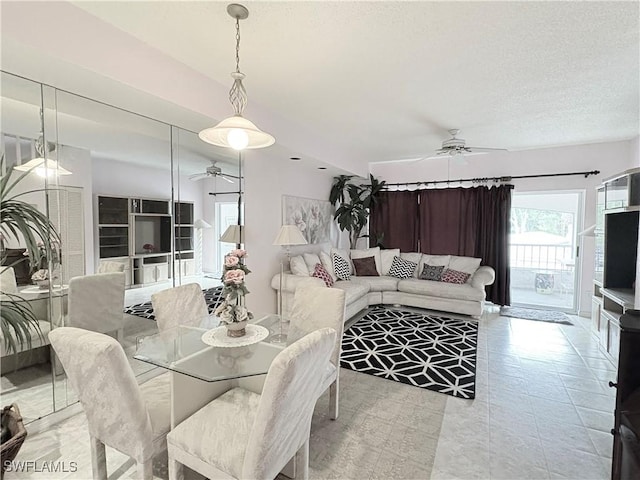 1096 Woodshire Ln Unit C205, Naples, FL 34105 - dining room featuring ceiling fan and a textured ceiling