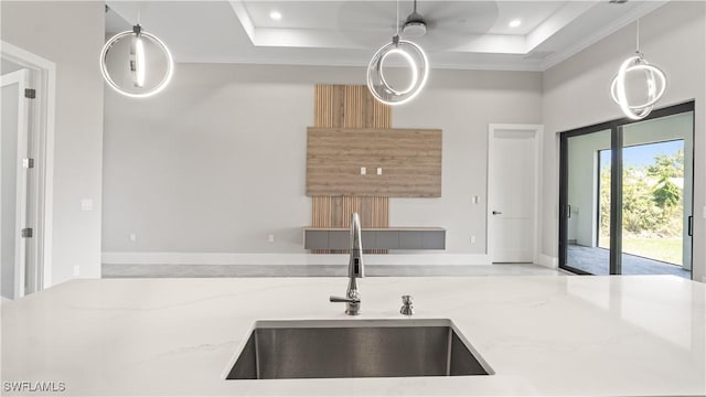 212 Connecticut Rd, Lehigh Acres, FL 33936 - kitchen featuring a sink, a raised ceiling, light stone countertops, hanging light fixtures, and recessed lighting