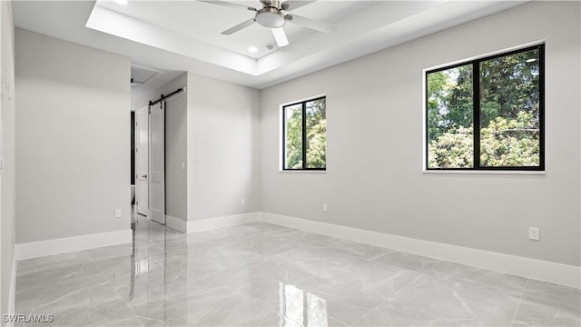 212 Connecticut Rd, Lehigh Acres, FL 33936 - empty room with light marble finish floors, baseboards, a barn door, ceiling fan, and recessed lighting