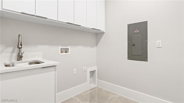 212 Connecticut Rd, Lehigh Acres, FL 33936 - washroom featuring cabinet space, electric panel, baseboards, light marble finish flooring, and washer hookup