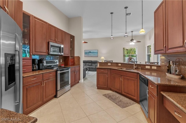 20408 Foxworth Cir, Estero, FL 33928 - kitchen featuring appliances with stainless steel finishes, a sink, decorative backsplash, ceiling fan, and decorative light fixtures