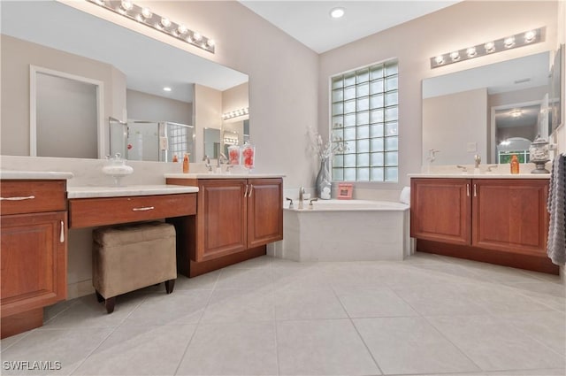 20408 Foxworth Cir, Estero, FL 33928 - bathroom featuring a shower stall, a bath, tile patterned flooring, and two vanities