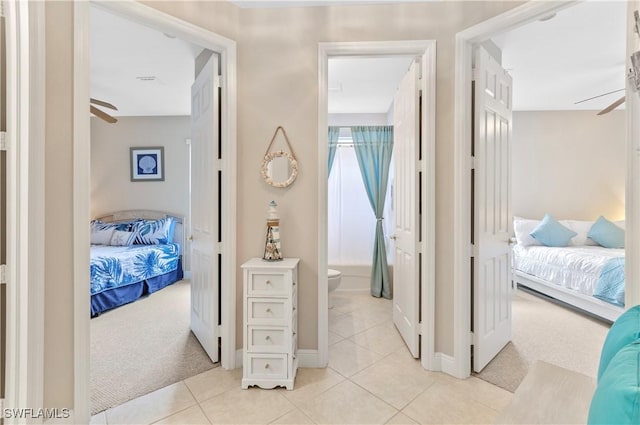20408 Foxworth Cir, Estero, FL 33928 - corridor featuring light carpet, light tile patterned flooring, and baseboards