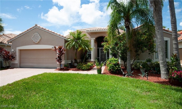 20408 Foxworth Cir, Estero, FL 33928 - mediterranean / spanish-style house with driveway, stucco siding, an attached garage, and a front yard