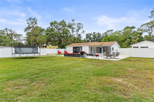 4411 Rose St, Valrico, FL 33596 - rear view of property featuring a trampoline, a patio, and outdoor lounge area