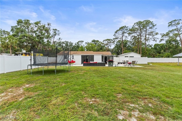 4411 Rose St, Valrico, FL 33596 - view of yard featuring a trampoline, an outdoor living space, and a patio area