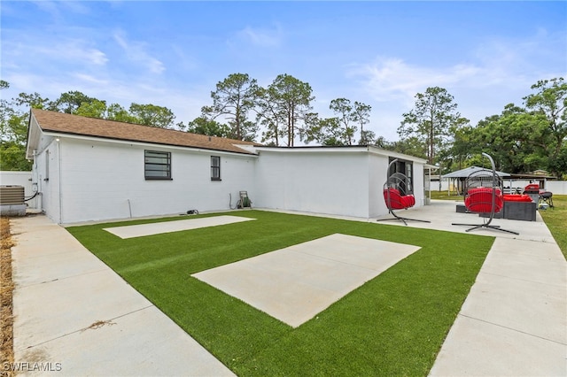 4411 Rose St, Valrico, FL 33596 - view of front facade featuring a front yard, central AC unit, and a patio area