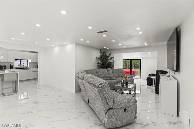 4411 Rose St, Valrico, FL 33596 - living area featuring recessed lighting, light marble finish flooring, and baseboards