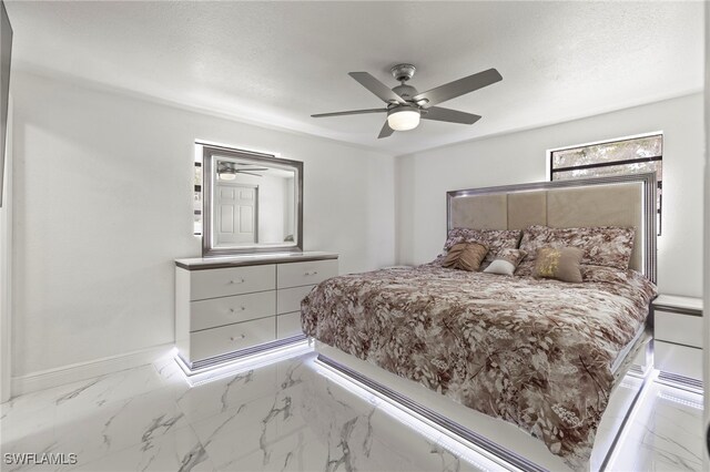 4411 Rose St, Valrico, FL 33596 - bedroom with baseboards, ceiling fan, and marble finish floors