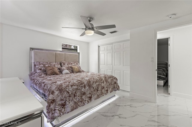 4411 Rose St, Valrico, FL 33596 - bedroom featuring a closet, ceiling fan, baseboards, and light marble finish flooring