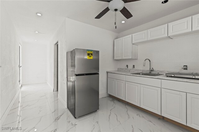 4411 Rose St, Valrico, FL 33596 - kitchen with freestanding refrigerator, a sink, ceiling fan, baseboards, and light marble finish flooring