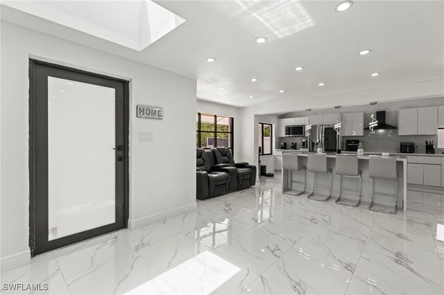 4411 Rose St, Valrico, FL 33596 - living room with recessed lighting, baseboards, and light marble finish flooring