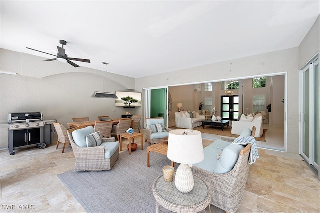 2026 Merlin Ct, Naples, FL 34105 - living room with ceiling fan and light stone finish flooring