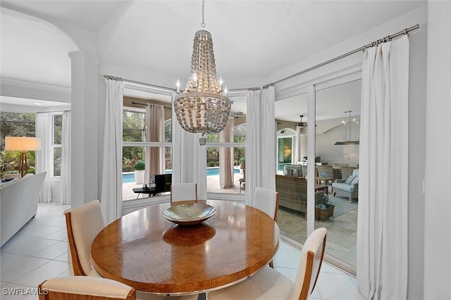 2026 Merlin Ct, Naples, FL 34105 - dining area with light tile patterned flooring, a chandelier, arched walkways, and ornate columns