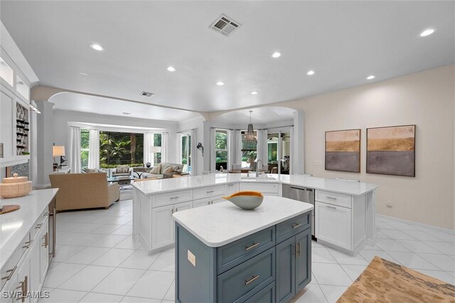 2026 Merlin Ct, Naples, FL 34105 - kitchen with a center island, arched walkways, a sink, stainless steel dishwasher, and open floor plan