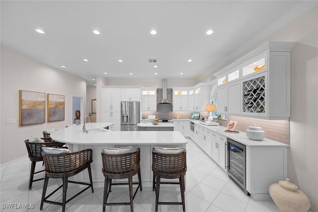 2026 Merlin Ct, Naples, FL 34105 - kitchen with stainless steel fridge, beverage cooler, a spacious island, a sink, and a breakfast bar