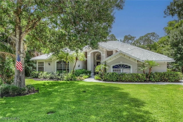 2026 Merlin Ct, Naples, FL 34105 - view of front facade with a front lawn, stucco siding, and a tiled roof