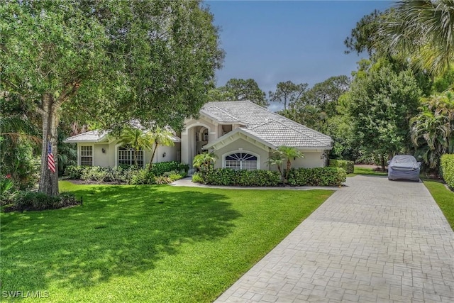 2026 Merlin Ct, Naples, FL 34105 - view of front of property with decorative driveway, stucco siding, and a front yard