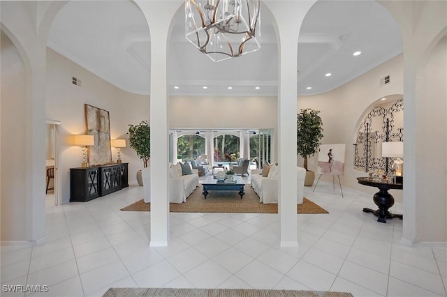 2026 Merlin Ct, Naples, FL 34105 - foyer featuring recessed lighting, a high ceiling, a chandelier, light tile patterned floors, and arched walkways