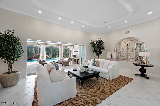 2026 Merlin Ct, Naples, FL 34105 - living room featuring recessed lighting, light tile patterned floors, a raised ceiling, a towering ceiling, and arched walkways