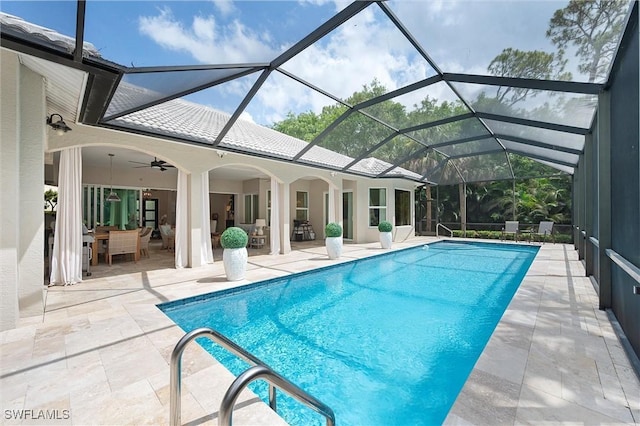 2026 Merlin Ct, Naples, FL 34105 - outdoor pool featuring a patio area, a ceiling fan, outdoor dining area, glass enclosure, and an outdoor living space