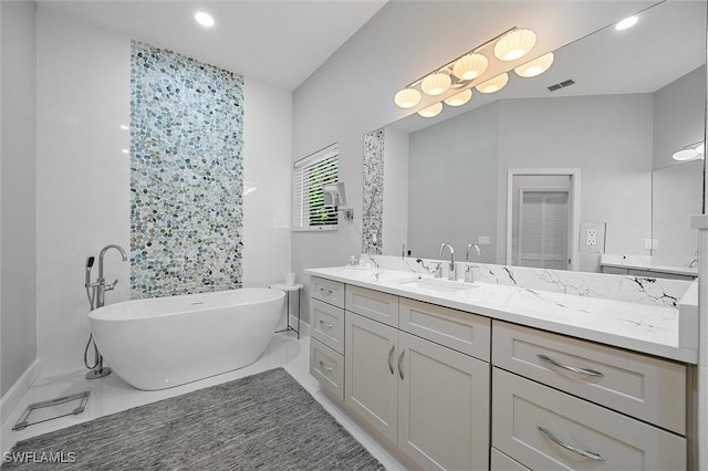 2026 Merlin Ct, Naples, FL 34105 - bathroom with a freestanding bath, vanity, and recessed lighting