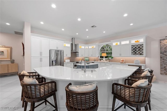 2026 Merlin Ct, Naples, FL 34105 - kitchen featuring stainless steel appliances, wall chimney exhaust hood, a sink, a large island, and decorative backsplash