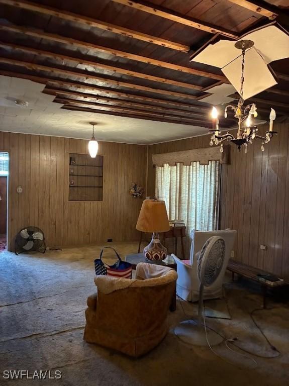 2994 Price Ave, Fort Myers, FL 33916 - living area featuring wood walls, plenty of natural light, a chandelier, and carpet flooring