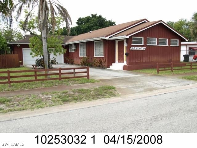 2994 Price Ave, Fort Myers, FL 33916 - ranch-style home featuring driveway, fence, and board and batten siding