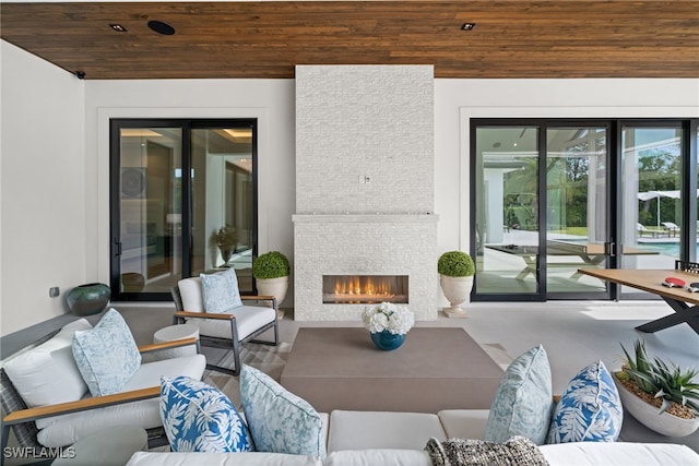 115 E Ave, Naples, FL 34108 - view of patio featuring an outdoor living space with a fireplace
