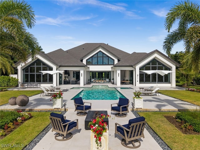 115 E Ave, Naples, FL 34108 - swimming pool featuring a patio, a lawn, and outdoor lounge area