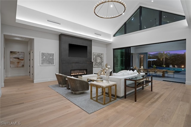 115 E Ave, Naples, FL 34108 - living area with wood finished floors, a fireplace, a towering ceiling, and baseboards