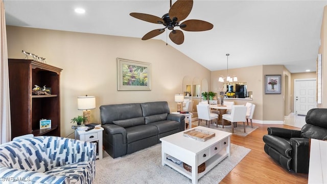 living room with ceiling fan, light wood-type flooring, a chandelier, lofted ceiling, and recessed lighting