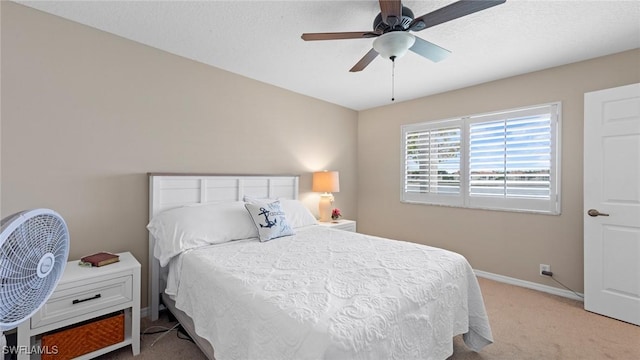 carpeted bedroom with baseboards and a ceiling fan