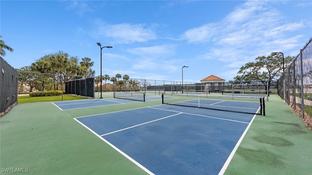 view of tennis court with fence