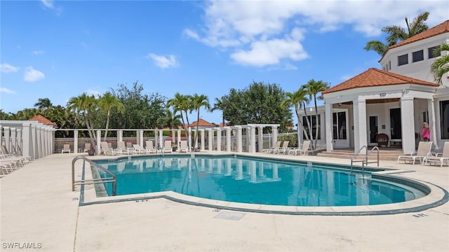 community pool featuring a patio area and fence