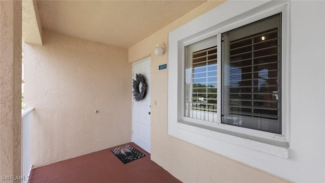 entrance to property with stucco siding