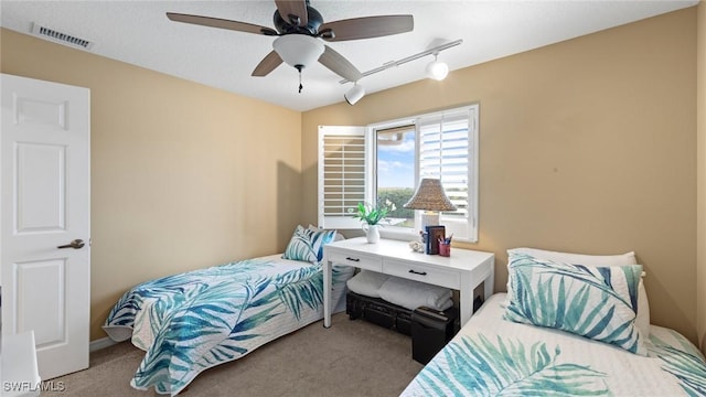 bedroom featuring carpet flooring, track lighting, and ceiling fan
