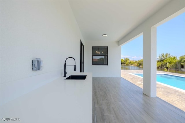 view of patio featuring a sink and fence