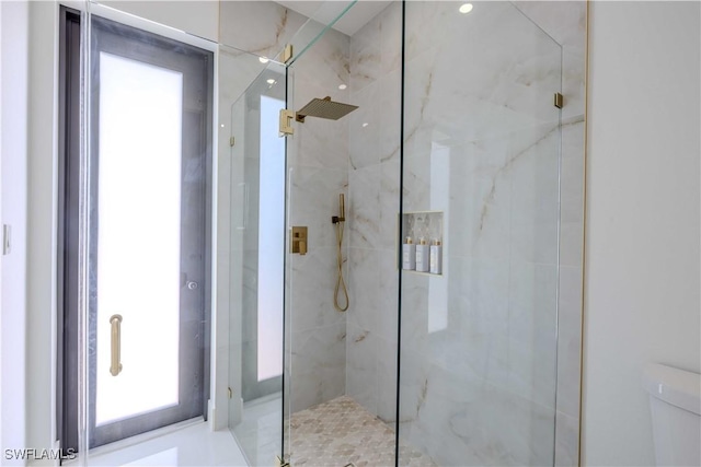 full bath featuring a marble finish shower and toilet