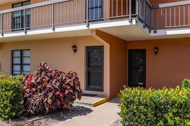 20 Greenbrier St Unit 3-105, Marco Island, FL 34145 - property entrance featuring a balcony and stucco siding