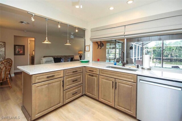 kitchen featuring dishwasher, a sink, light wood-style floors, hanging light fixtures, and recessed lighting